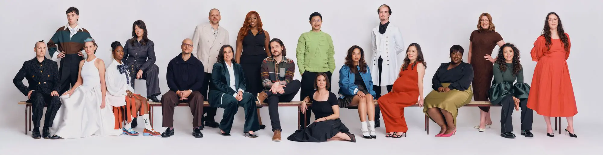 A long image of all the BAFTA UK Breakthroughs sat on a bench.