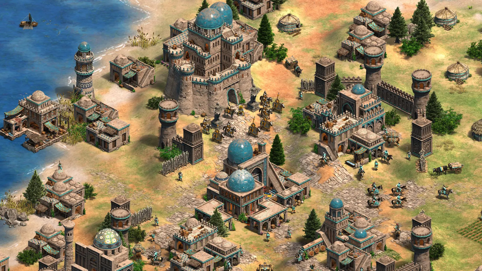A still of the game Age of Empires. Multiple historic looking brick building with blue domed roofs in green landscape bordered by the sea.