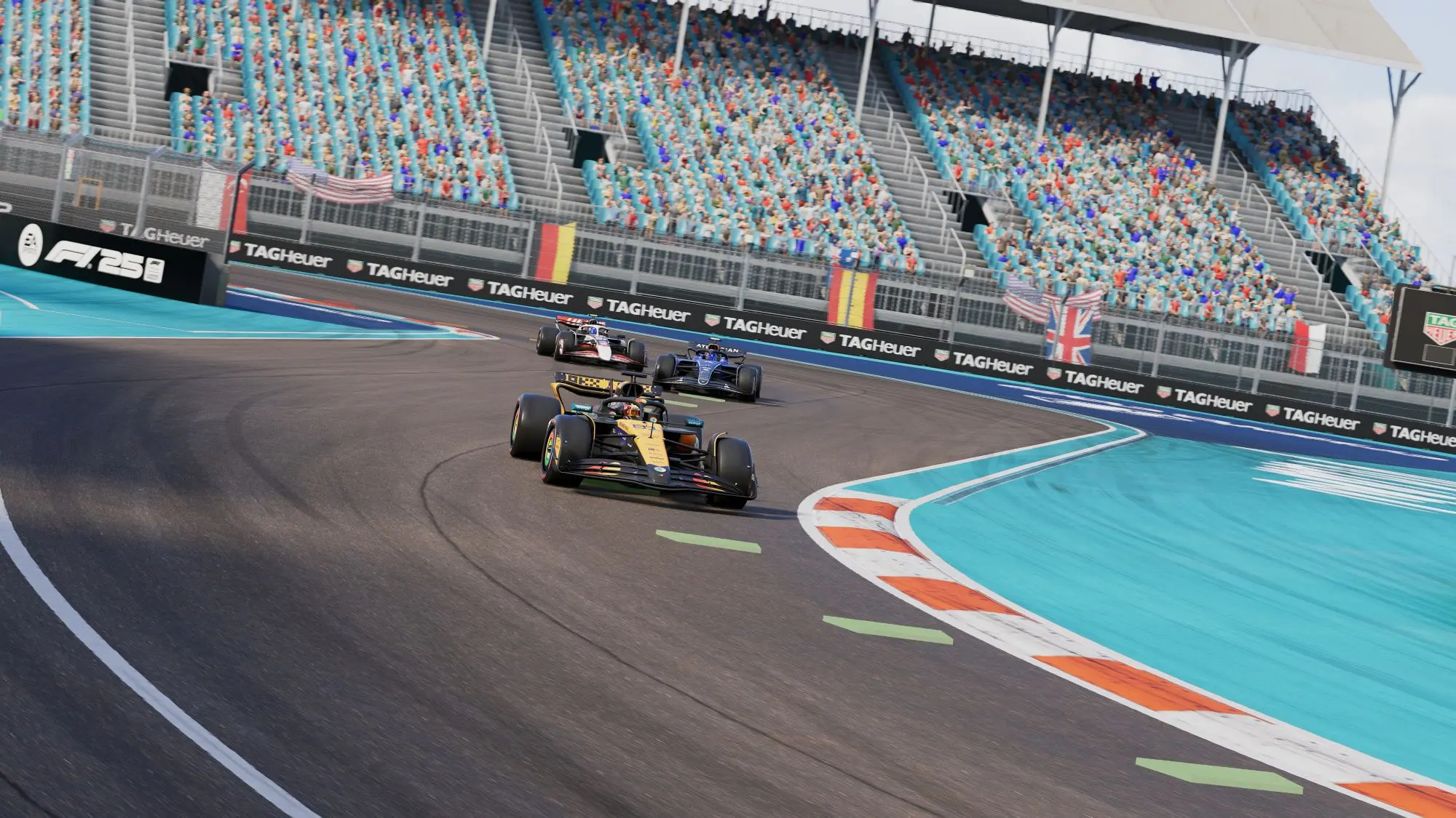 A still from the game F1 25. Three racing cars going around the bend on a track as an audience watches.