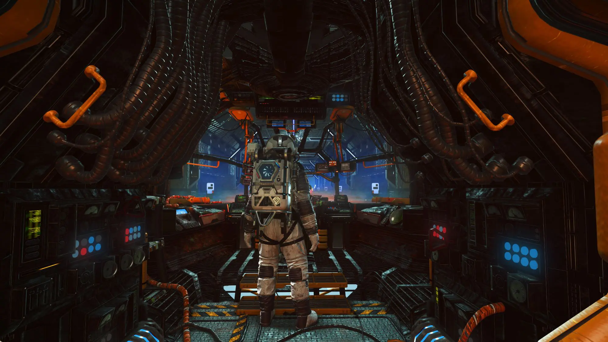 A still from the game No Man's Sky. A figure in a spacesuit stands in some kind of space capsule.