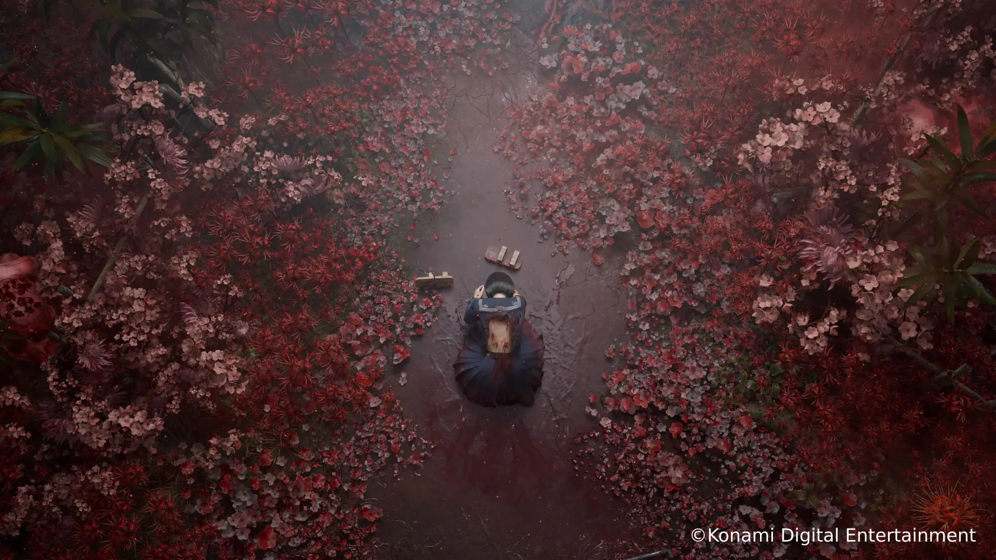 A still from the game SILENT HILL f. A female figure kneeling on the floor of a forest surrounded by red flowers. She is wearing a blue sailor-collared dress and has bleeding cuts on her back.
